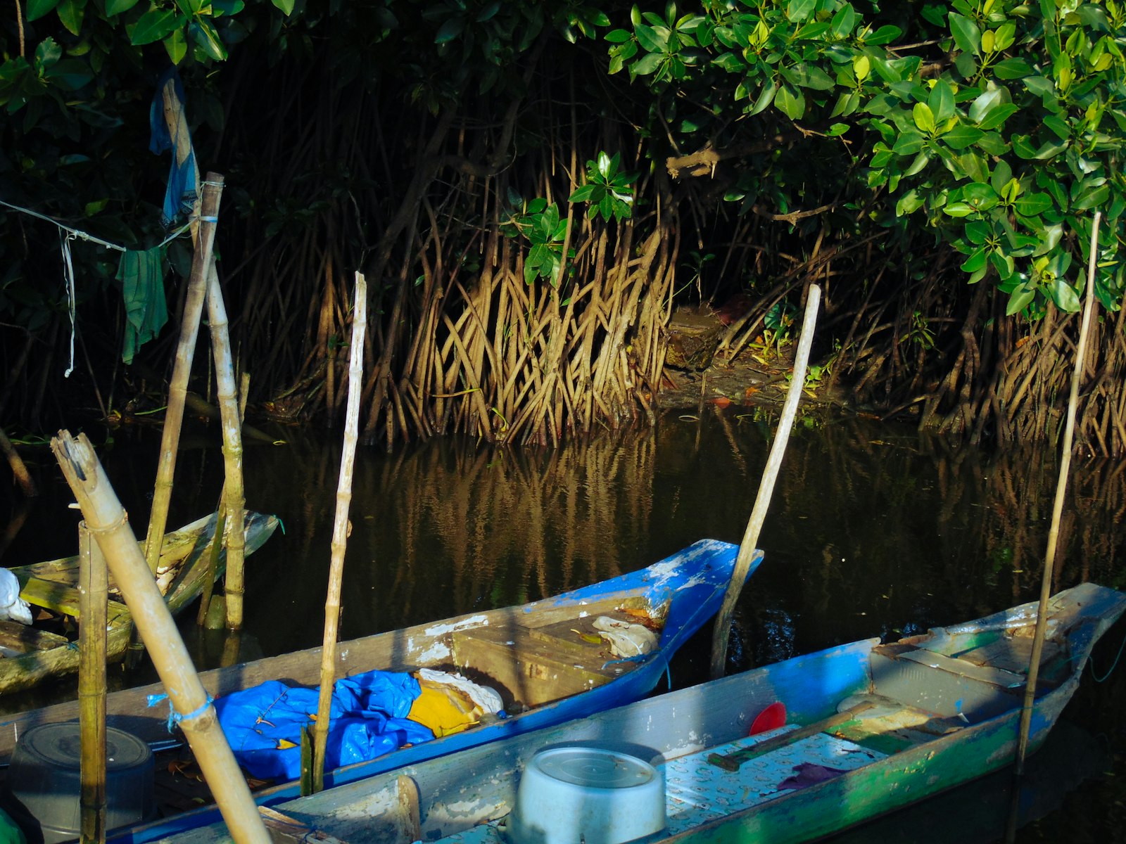a small blue boat floating on top of a river